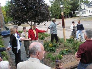 New Eagle Scout Eric Lusardi, at left, brought a New Peace Site and personally designed Peace Pole to life in New Richmond WI in the summer of 2012.  Melvin Giles, center, helps dedicate the Peace Site on the International Day of Peace Sep 21, 2012.