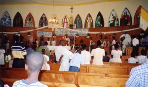 Fr. Jean-Juste saying Mass at Ste. Claire Dec 7 2003 (both photos by Dick Bernard)