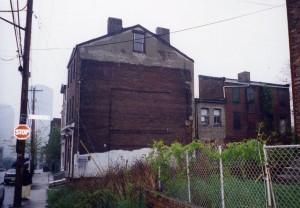 August Wilson boyhood home was in building at right in the photo, 1727 Bedford Avenue.  Entrance was from back side of the building.  Note in background the skyline of downtown Pittsburgh, a few blocks down the hill.