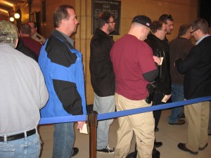 In line.  Note the holstered handgun