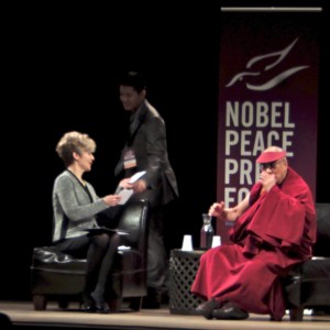 Tenzin Yeshi Paichang gives question for Dalai Lama to Kathleen Wurzer, conversation moderator.