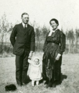 Ferd and Rosa Busch with first child, Lucina, in yard of their farm home likely Fall 1907