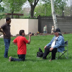 Entasham (at left) interviewing Native American author and Vietnam War vet Jim Northrup at the MN Vietnam Memorial Vets for Peace event, Memorial Day, 2014.  Cameraman fellow Pakistani, Suhail.  See Postnote