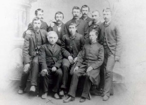 The Collette men in Oakwood ND 1887 likely after the death and burial of their wife and mother Mathilde.  Dad is front left; the Priest is at front right. 