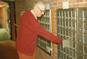 Checking for a "postal" in the days before computers took over.  I doubt he ever actually touched a computer!
